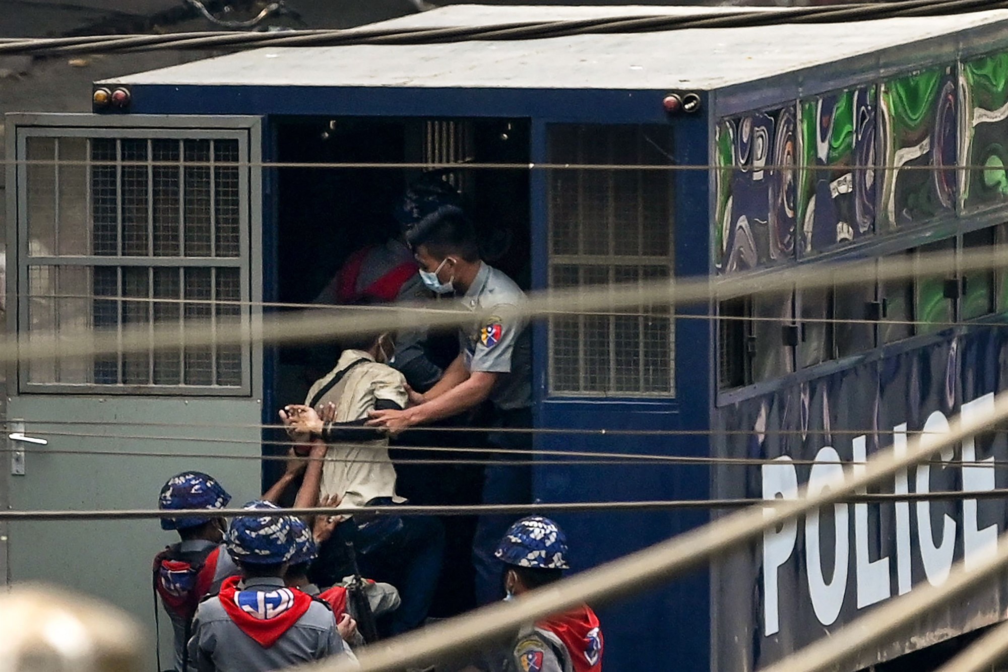 Police arrest a man in Yangon on Saturday, after a crackdown on demonstrations by protesters against the military coup.SAI AUNG MAIN / AFP - Getty Images