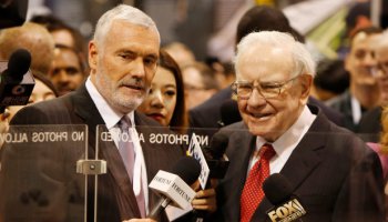 Warren Buffett, right, talks with Mark Donegan, CEO of Precision Castparts, at the Precision Castparts booth in exhibit hall during the Berkshire Hathaway Annual Shareholders Meeting at the CenturyLink Center in Omaha, Nebraska on April 30, 2016.